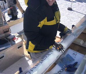 A person bagging an ice-core sample in a transparent plastic bag