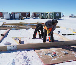 Two people doing various jobs around the ice-core site