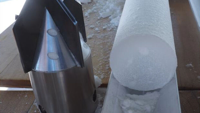 A conical drilling device sitting beside an ice core.