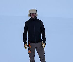 A portrait photo of Antoine the station chef standing on the ice wearing his cold weather gear.