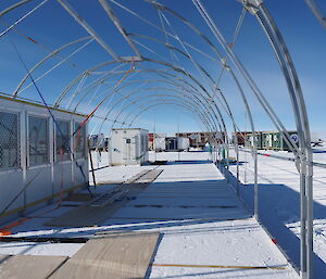 The semi-circular metal frame of the drill shelter ready to be covered by a tarpaulin.