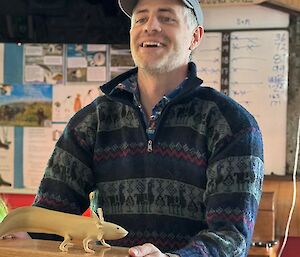 A man with a model of an axolotl