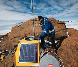Peter Caithness at the top of Mt Parsons checking the repeater antenna