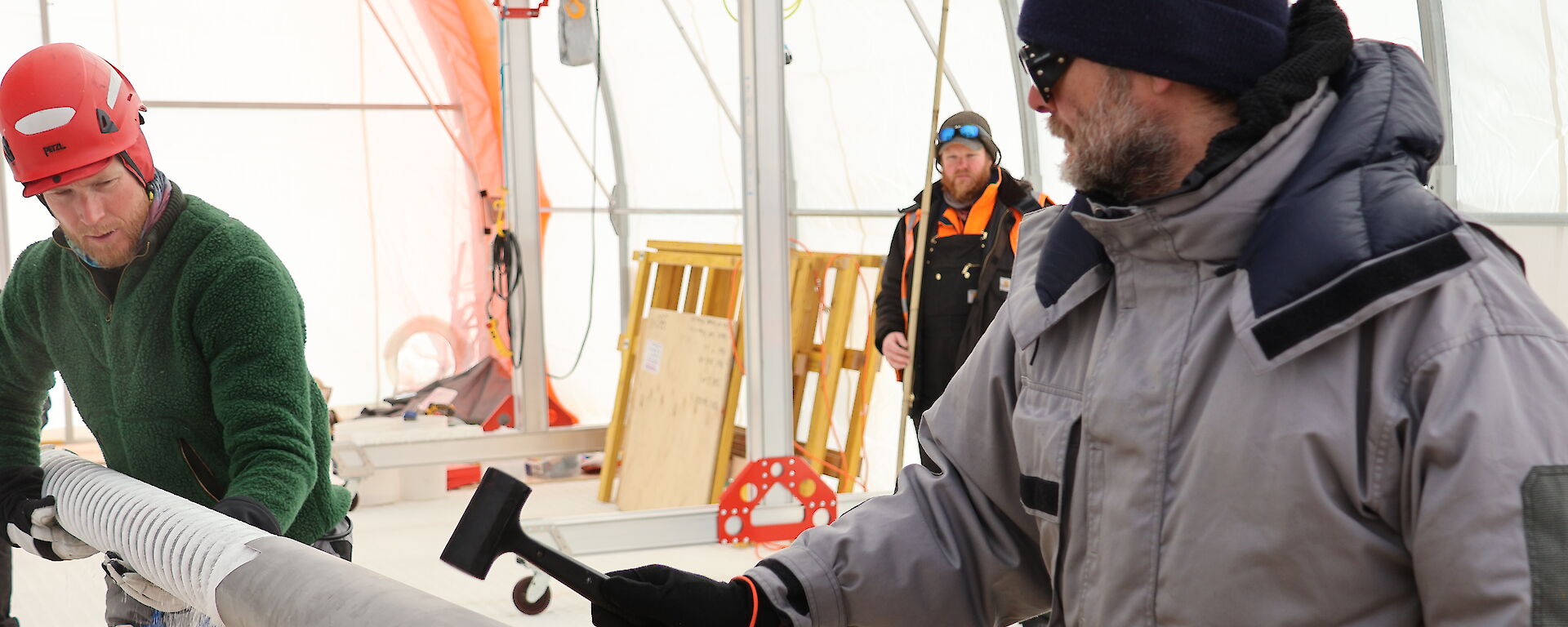 Two expeditioners working on the ice core