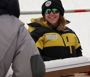 A woman standing in front of an ice core on a table