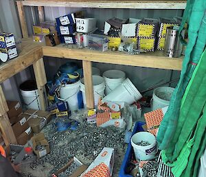 A messy set of shelves with building materials on them