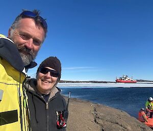 A sunny day picturing the incoming and outgoing Station Leaders, Dave and Ali, with Nuyina in the background, as expeditioners arrive by PTT onto East Arm