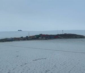 RSV Nuyina in Kista Strait with a view of station and the plateau behind plus the tip of Mt Henderson from the ship