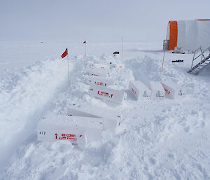 White, rectangular boxes sitting on the top of snow