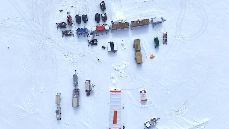 Aerial view of the ice core camp showing tractors, large tents and rectangular accommodation vans