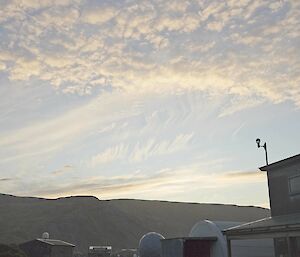 High cloud, formed into little puffs high in a pale blue sky