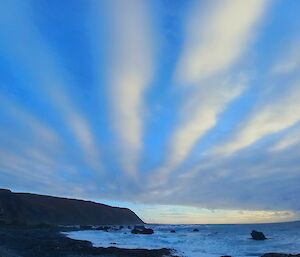 Vertical striped clouds over the island's southern headland