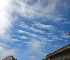 Some stripey, some wispy clouds over the station buildings