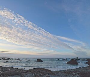 Beautiful sweep of sunset-tinged cloud over the water