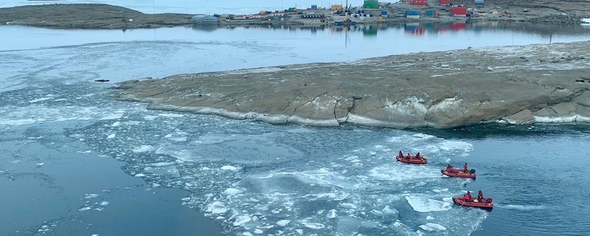 3 IRBs out on the water with Mawson station in the background