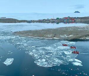 3 IRBs out on the water with Mawson station in the background