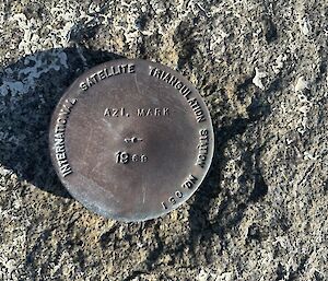 A metal disc on a rock