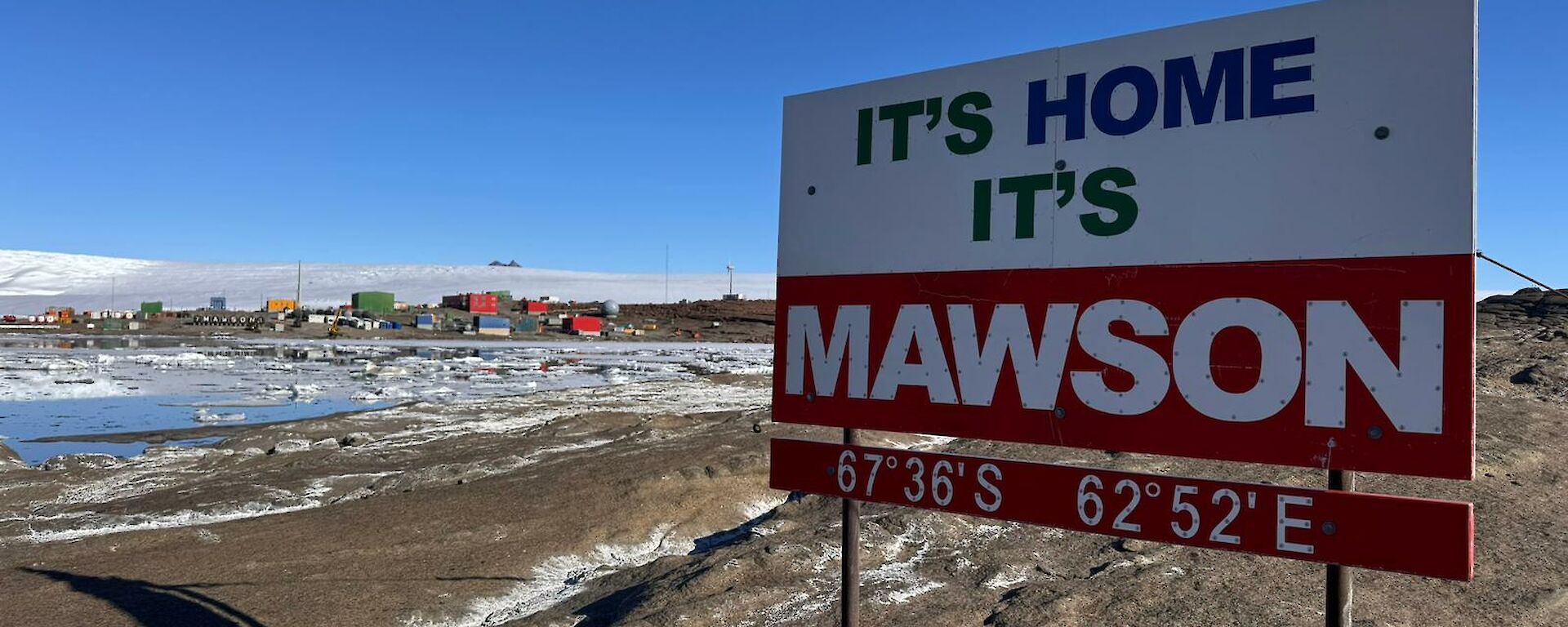 A sign on a rock saying 'It's Home, It's Mawson'
