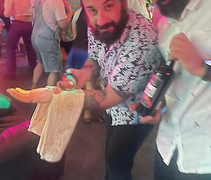 Image of person with wine bottle pretending to serve drinks.