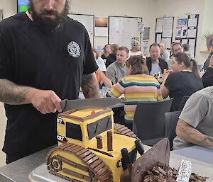 Image of expeditioner cutting cake with a knife.