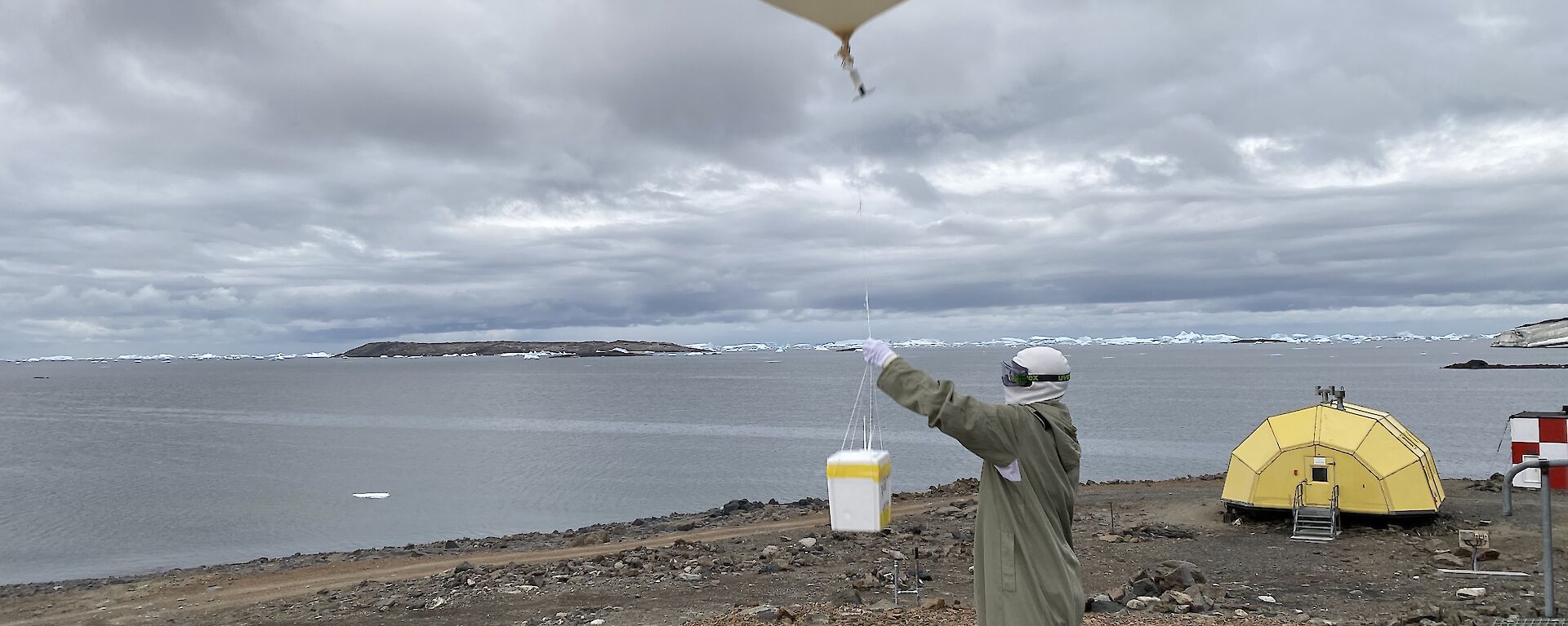 A large white balloon being released into the sky.
