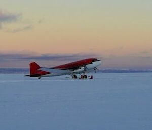 Image of two DC3 Baselr Aircraft and one twin Otter Aircraft at the Casey Skiway at sunrise.