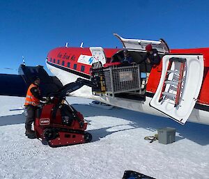 Image of DC3 Basler aircraft being loaded with cargo.