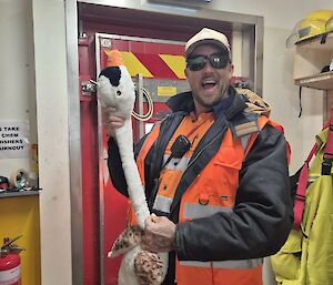 Image of expeditioner holding plush toy.