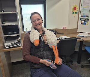 Image of plush toy draped around expeditioners neck.