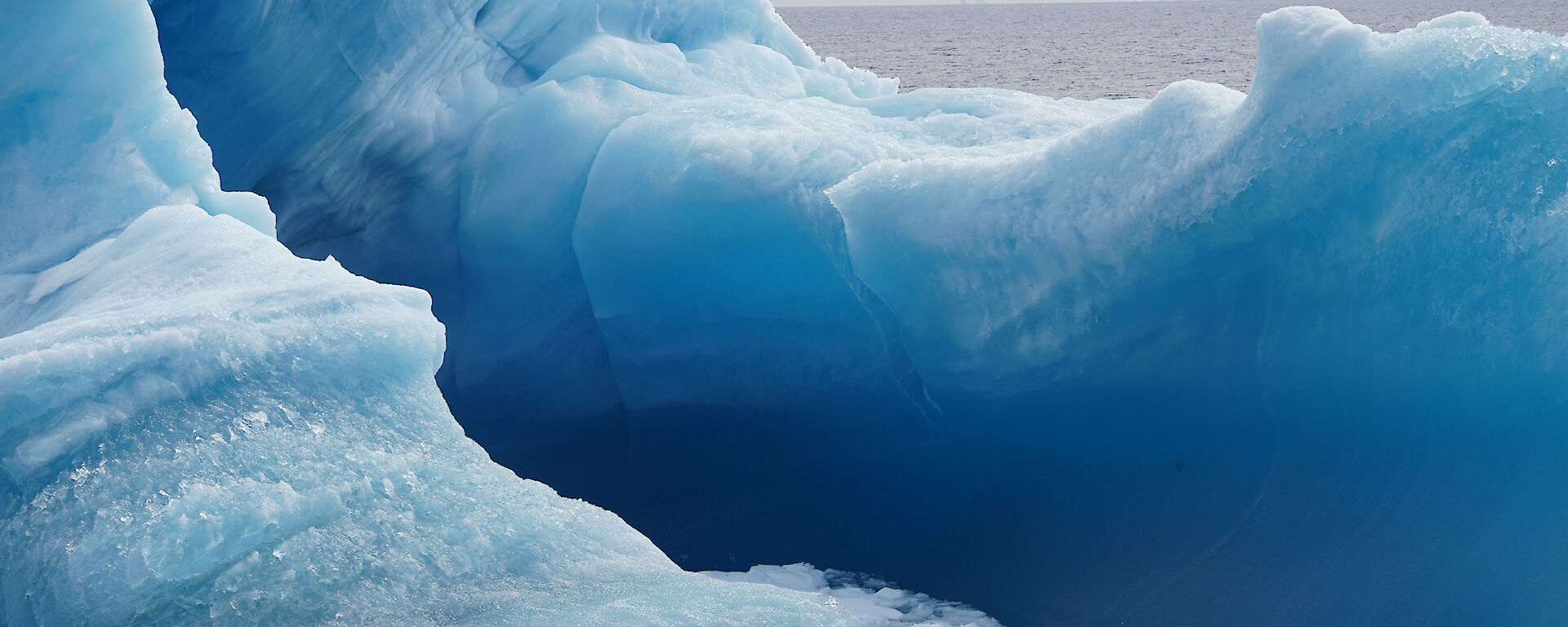 A dark blue and white iceberg