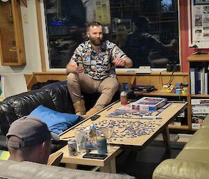A man sitting on a couch in the dining room