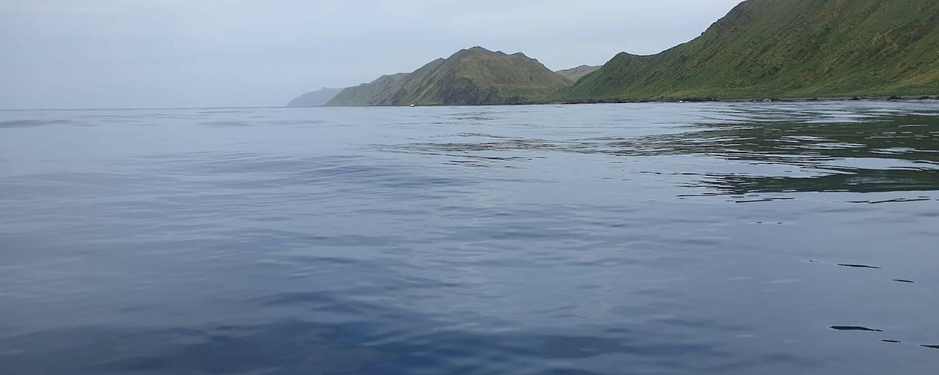 Photo taken from the IRB of smooth 'glassy' water conditions and island in the distance