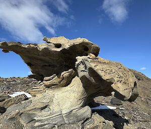 A rock carved into an unusual shape by wind and ice