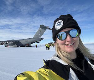 A blonde woman with a C17 RAAF aircraft behind her on an ice runway