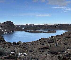 A rocky landscape with a lake in the middle