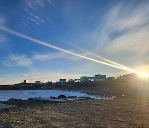 The sun rising over the buildings of Davis station in Antarctica