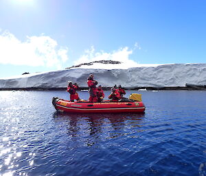 Expeditoners on a red inflatable boat