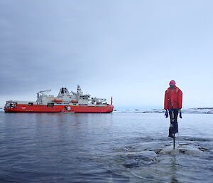 RSV Nuyina, in front of a scarecrow in the water