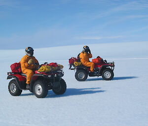 Two expeditioners both on quad bikes on the ice