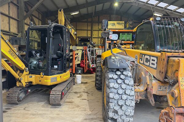 Machinery Shed with excavator on left and JCB parked on right