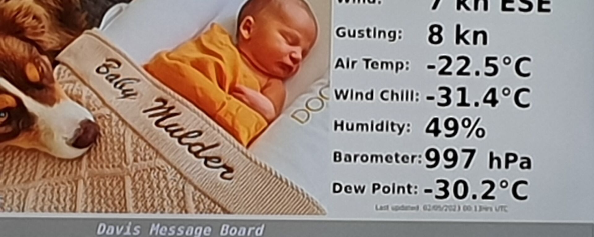 A photo of a newborn baby asleep, on the station's message board