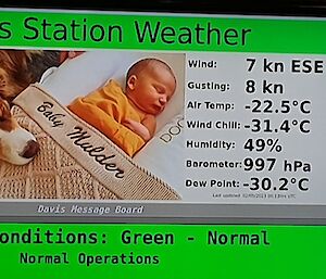 A photo of a newborn baby asleep, on the station's message board