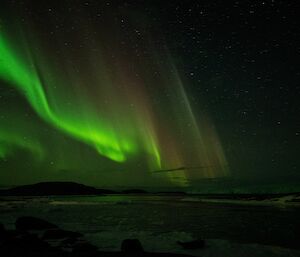 Wavy green light shimmers over the station