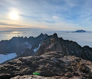 View from a rocky mountain over a vast white plain