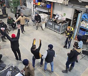 People playing two up in a shed