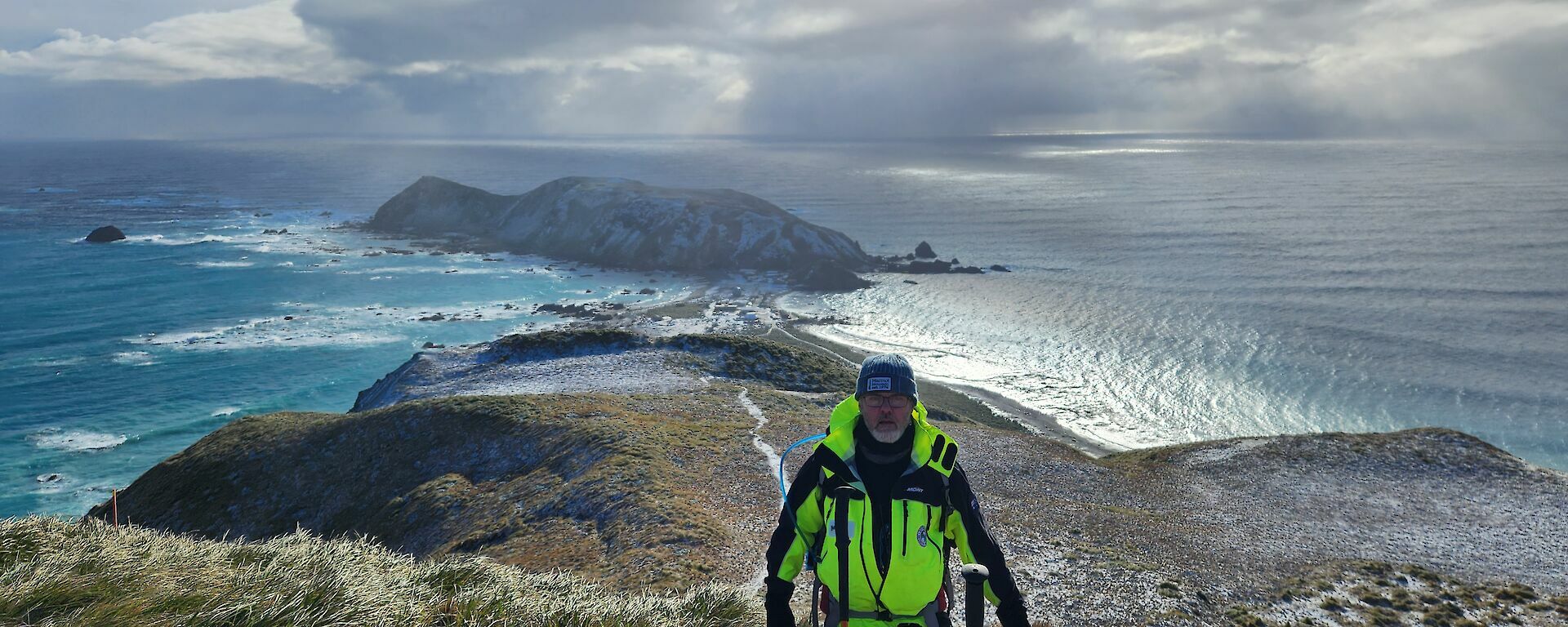 A man standing in front of a backdrop of Macquarie Island