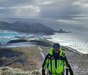 A man standing in front of a backdrop of Macquarie Island