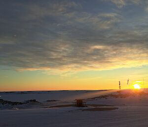 Sunrise coming up over the ice at Casey Station