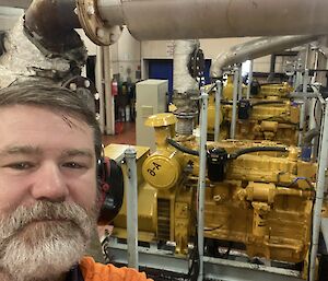 A man standing in front of diesel generators