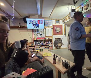 People in front of a darts board